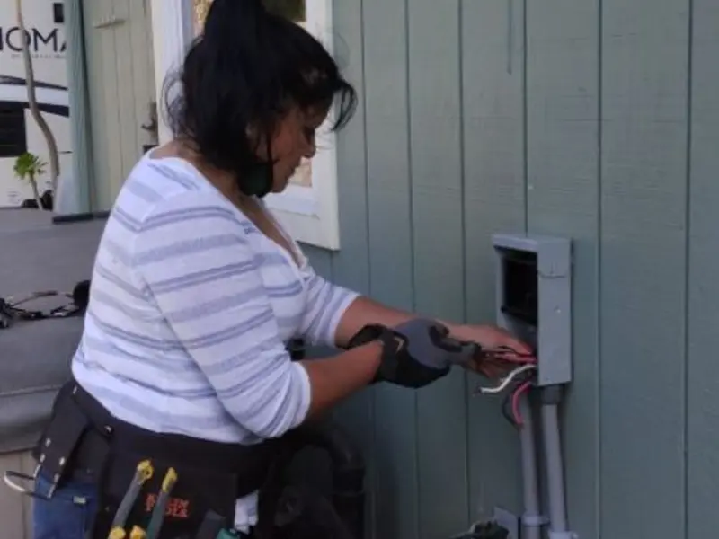 Licensed electrician wiring an exterior subpanel in Pine